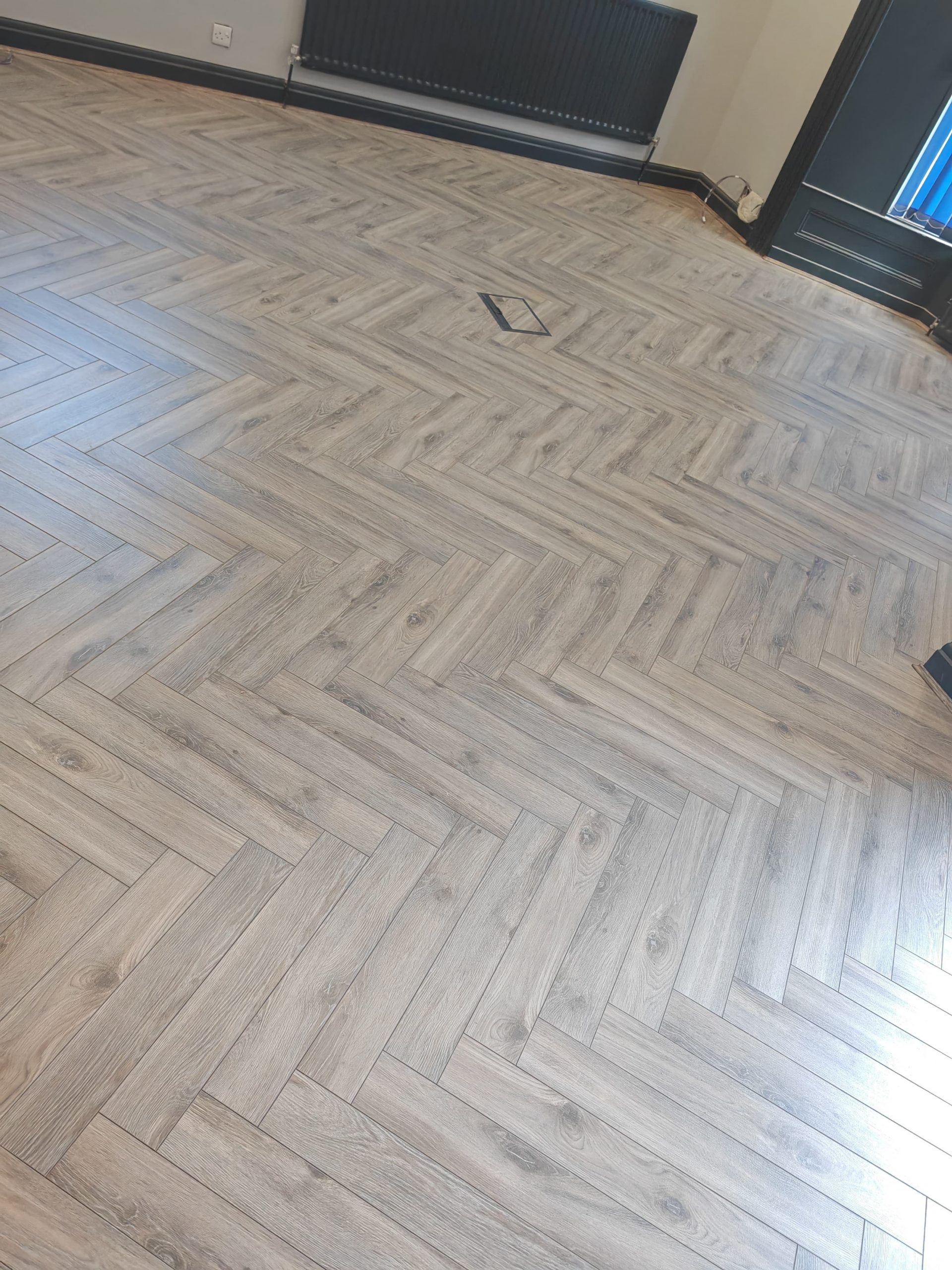 Volcanic oak herringbone flooring in living room