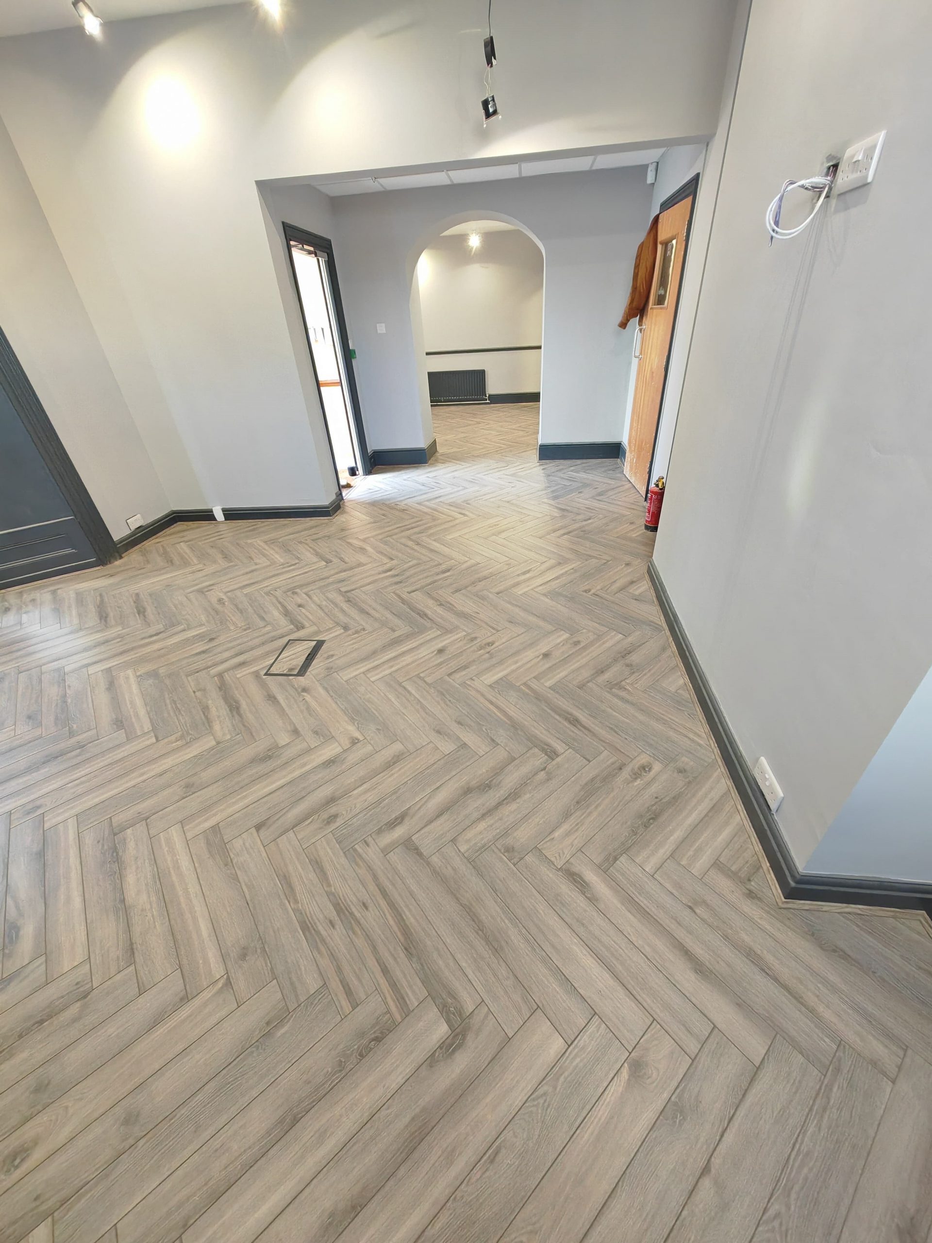 Volcanic oak herringbone in open room